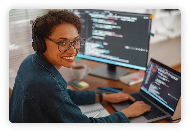 Woman with headset on at a computer