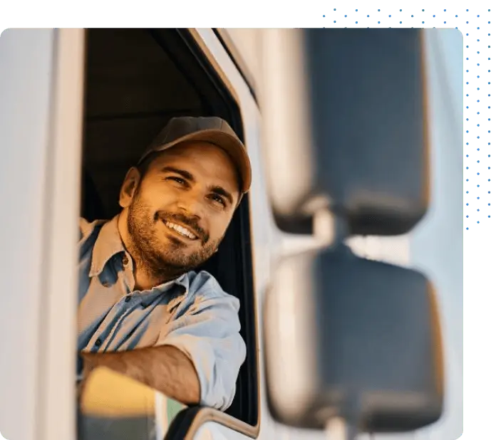 Driver smiling out the window of his truck